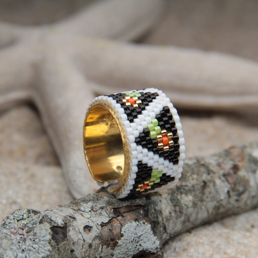 Hand-woven stainless steel ring with mustard seeds, traditional Colombian art for wearing.